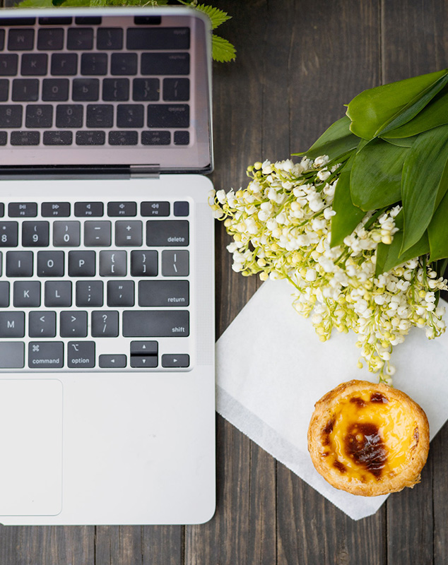 photo of laptop on desk with flowers
